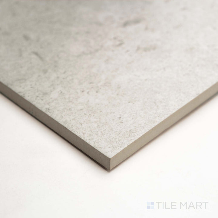 A refined angle shows Pietra Coral Pearl 12X36 in matte, revealing soft veining and balanced neutral palette.