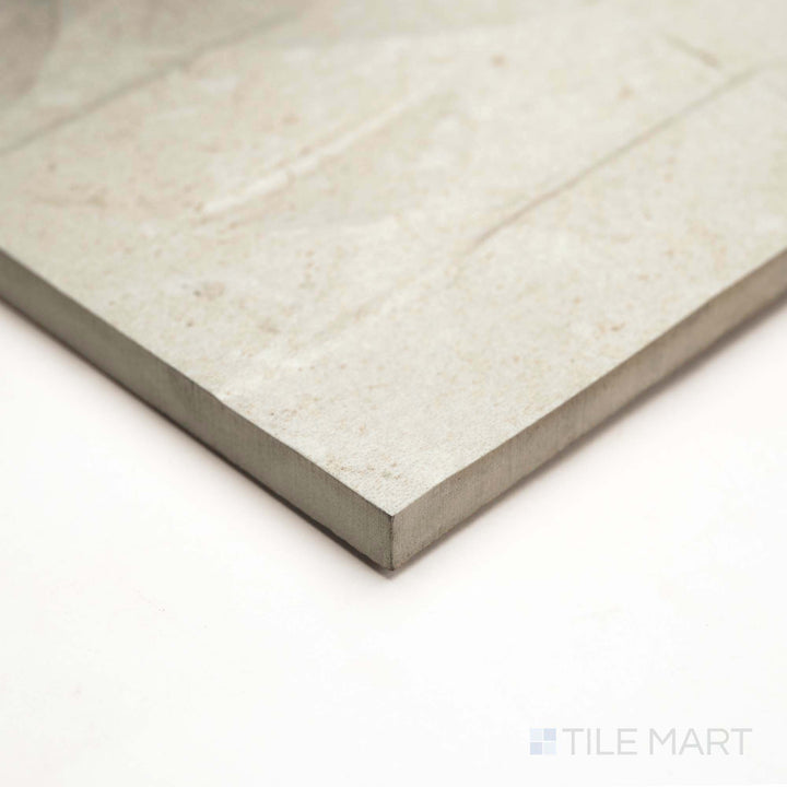 Deco version of Pietra Coral Natural 12X36 captured in corner shot, featuring intricate stone-inspired surface detail.