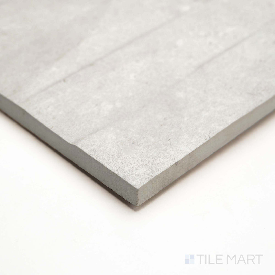 Corner angle of Pietra Coral Pearl Deco 12X36 showcases subtle patterning with a matte finish for added dimension.