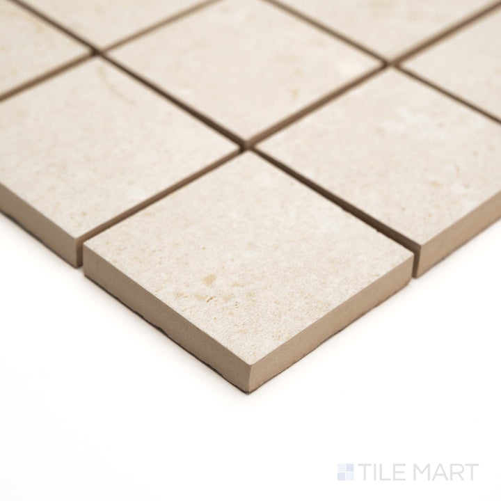 Corner angle captures Pietra Coral Natural 2" Square mosaic in matte finish with a clean, structured stone pattern.