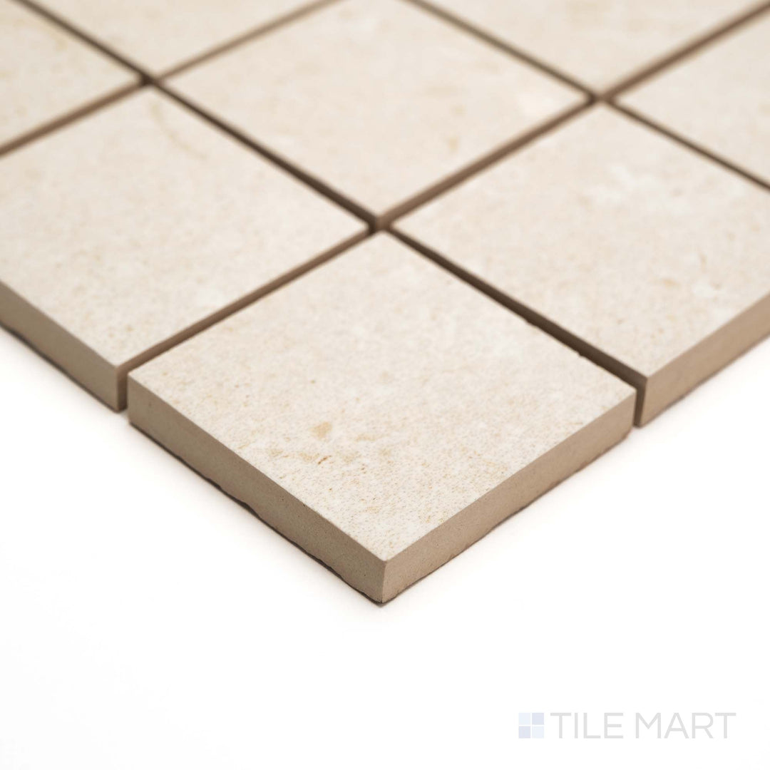 Corner angle captures Pietra Coral Natural 2" Square mosaic in matte finish with a clean, structured stone pattern.