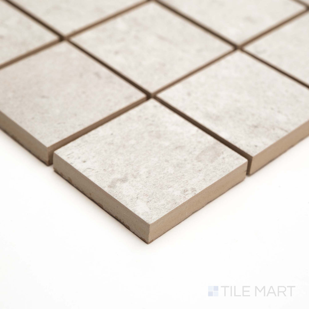 Subtle variations in Pietra Coral Pearl 2" Square matte mosaic are revealed in this elegant corner view.