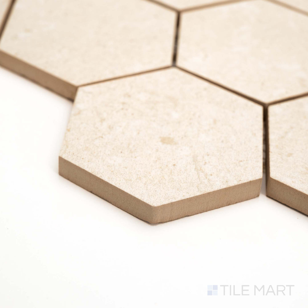 From the corner, the Pietra Coral Natural 3" Hexagon matte mosaic shows off its geometric form and warm earth tones.