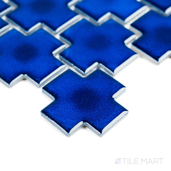 Cobalt Blue Cross matte porcelain mosaic is seen from a corner angle, showing off its vivid color and crisp shape.