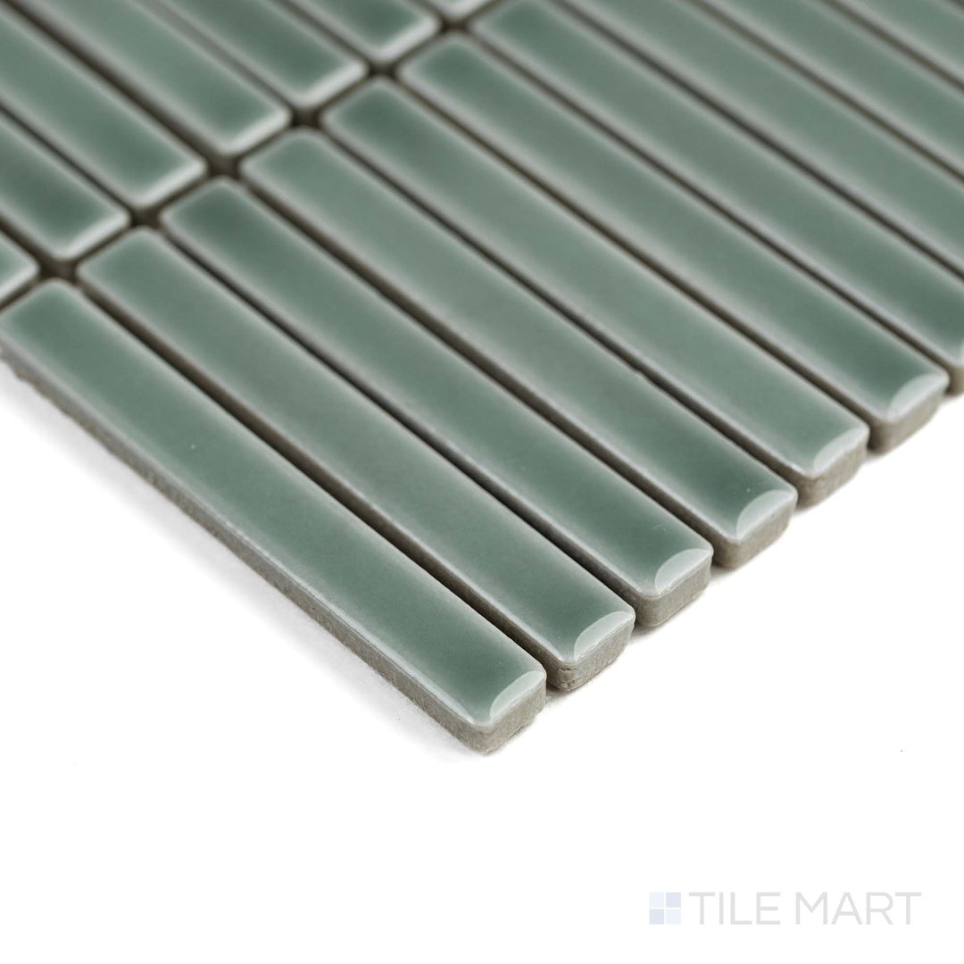 Aged Grey Mini Sticks porcelain mosaic in a glossy finish reflects light beautifully in this angled corner view.