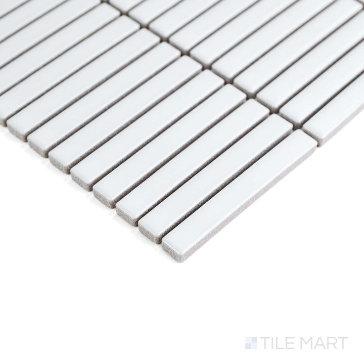 White Mini Sticks matte porcelain mosaic is captured from the corner, emphasizing its sleek linear texture.