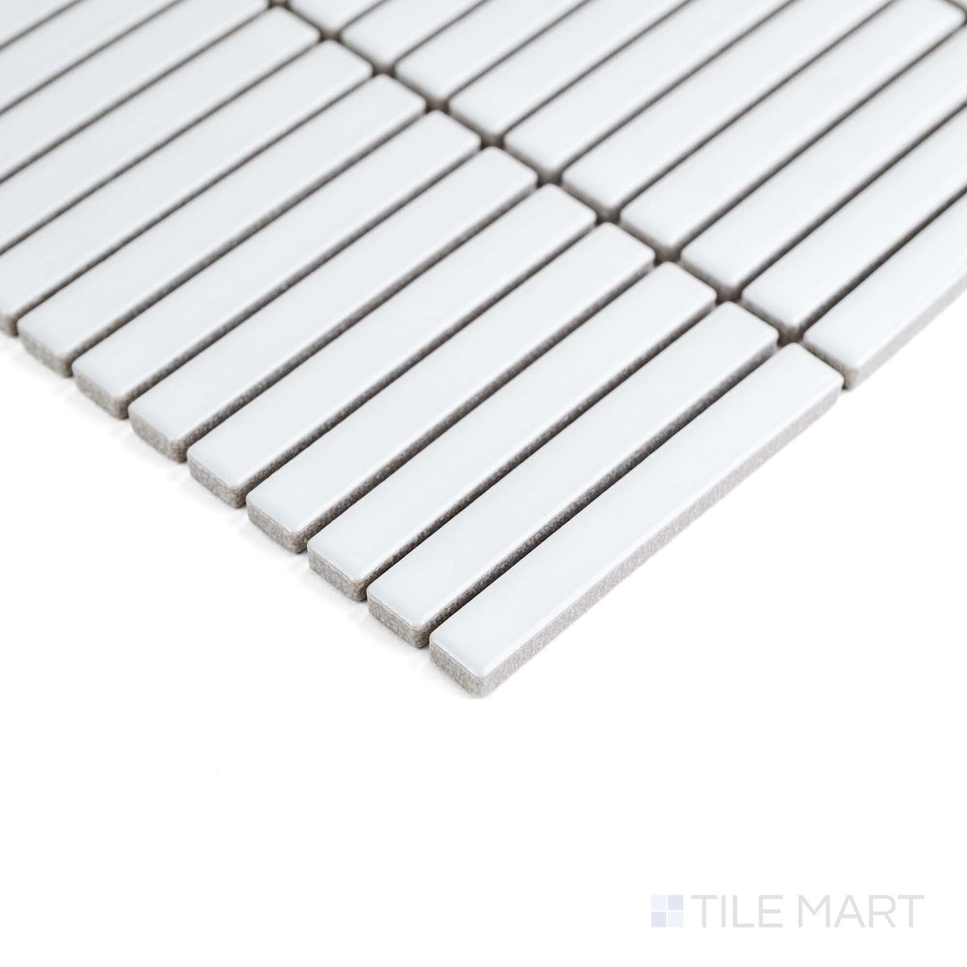 White Mini Sticks matte porcelain mosaic is captured from the corner, emphasizing its sleek linear texture.