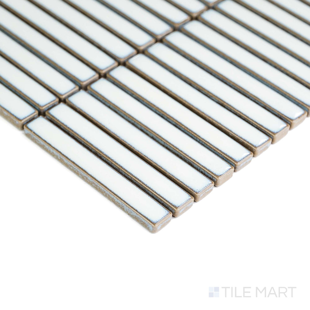 In this corner shot, Aged White Mini Sticks matte porcelain mosaic reveals soft tones and subtle surface variation.