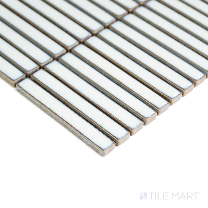 In this corner shot, Aged White Mini Sticks matte porcelain mosaic reveals soft tones and subtle surface variation.