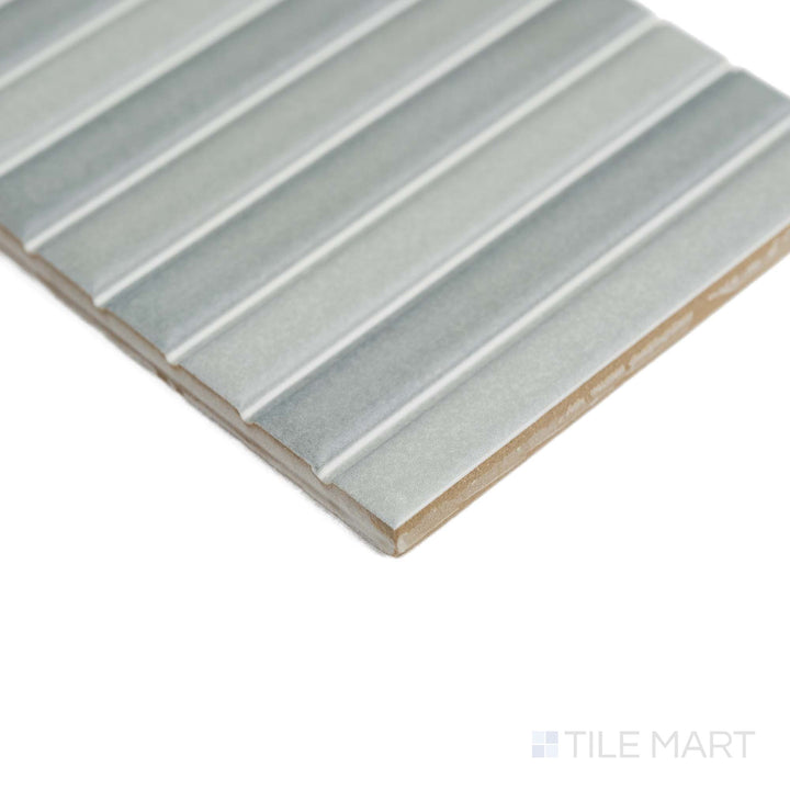 Roku Grey 4.5X9 tile is captured from a corner angle, showcasing its soft matte finish and modern look.