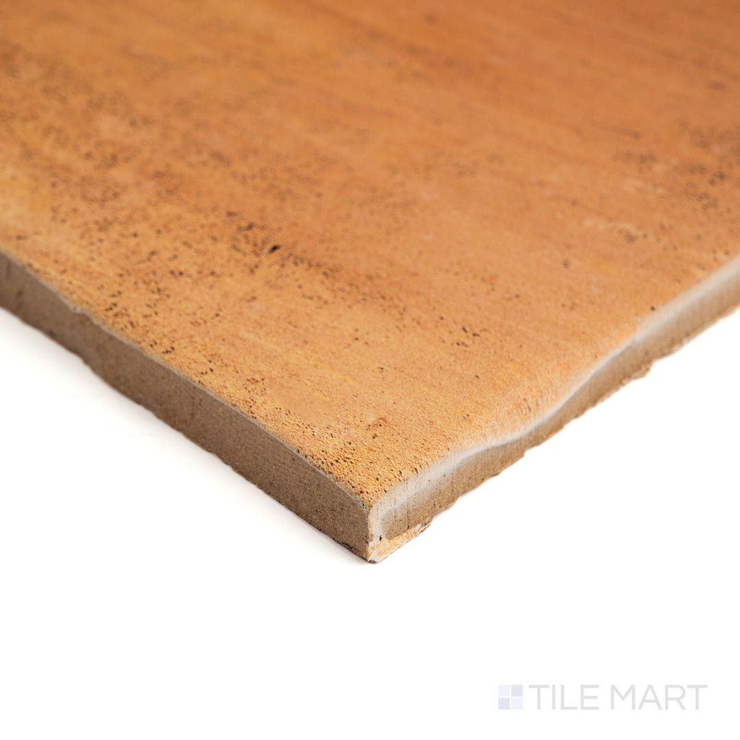 Corner view of Fuego Antic 18x18 matte porcelain tile, showing its weathered surface, earthy coloration, and the tile's full edge profile from an angle.