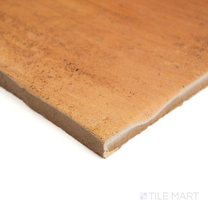 Corner view of Fuego Antic 18x18 matte porcelain tile, showing its weathered surface, earthy coloration, and the tile's full edge profile from an angle.