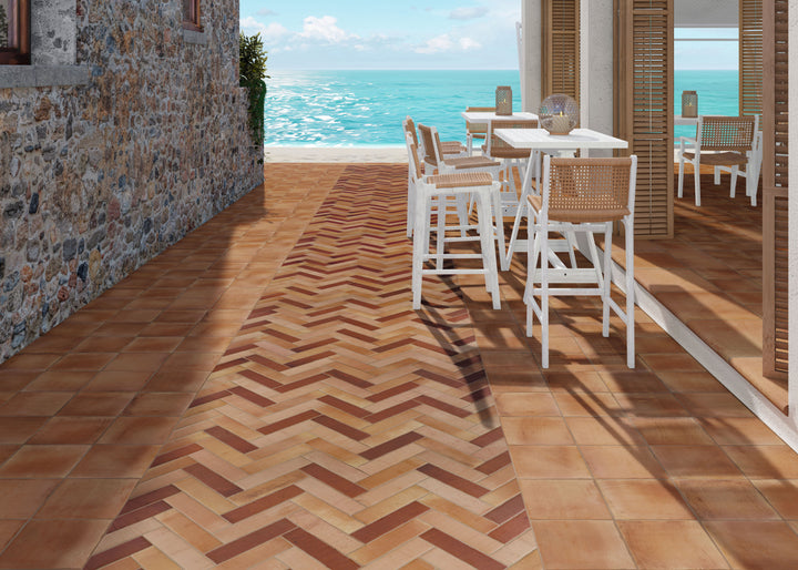 Installed view of Fuego Antic 9x9 matte porcelain tile, showcasing its time-worn texture, earthy hues, and vintage-inspired appearance.