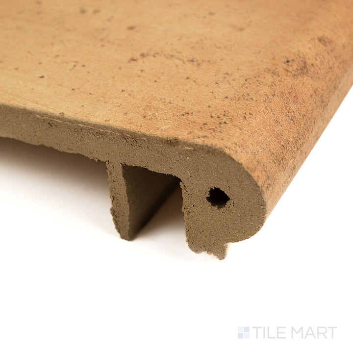 Corner angle of Fuego Antic Stair Coping 13x18 matte porcelain tile, showcasing its rounded bullnose edge, rustic surface, and sturdy side profile.