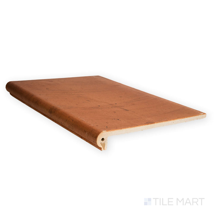 Captured from a top-down perspective, this Fuego Teja Stair Coping 13x18 matte porcelain tile displays warm tones, textured surface, and coping edge design.