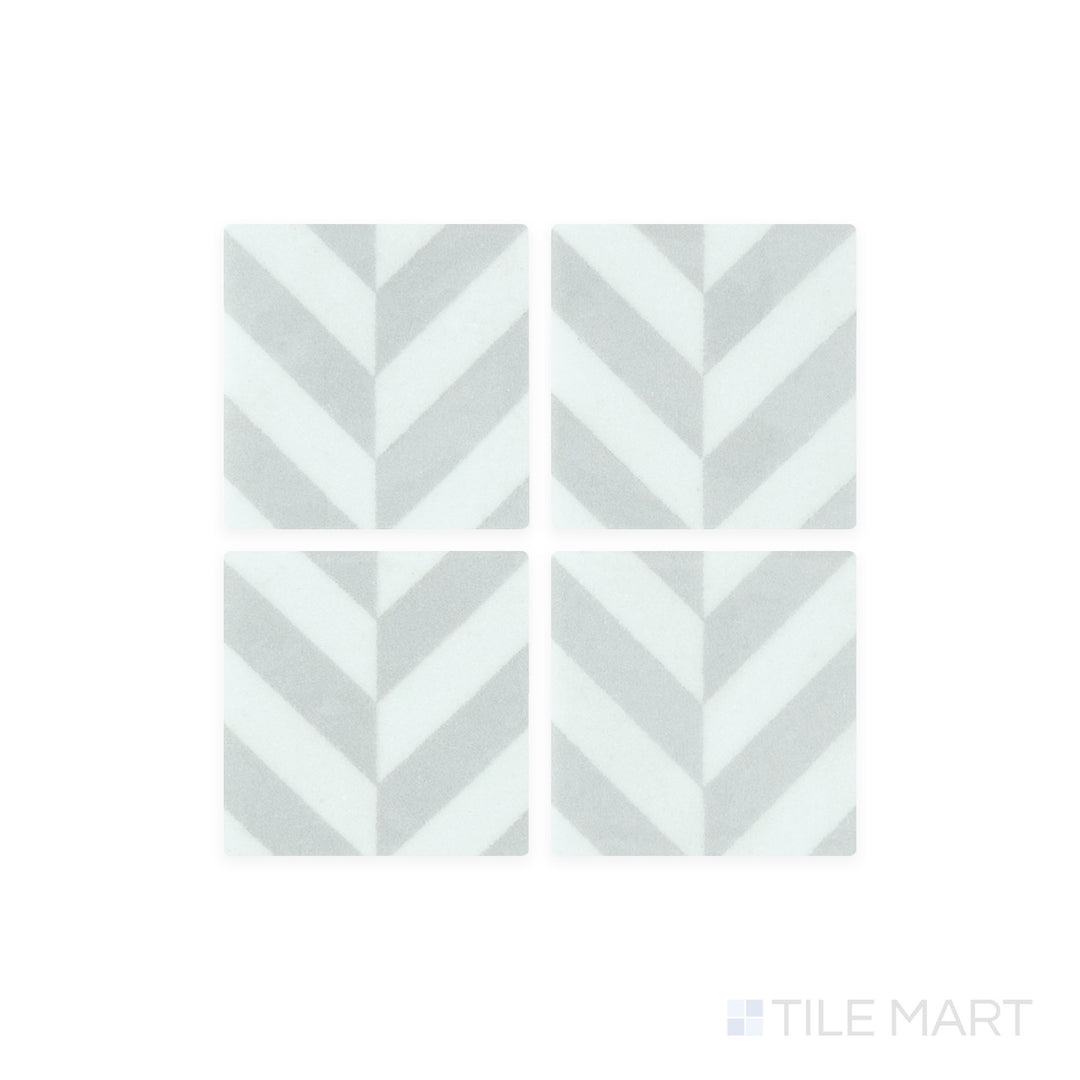 A close-up shot of Onix Glass - Icon Light Grey 2" Square Chevron Matte, Gloss Mosaic tile reveals its subtle grey hue with a delicate mix of matte and gloss textures for a modern aesthetic.