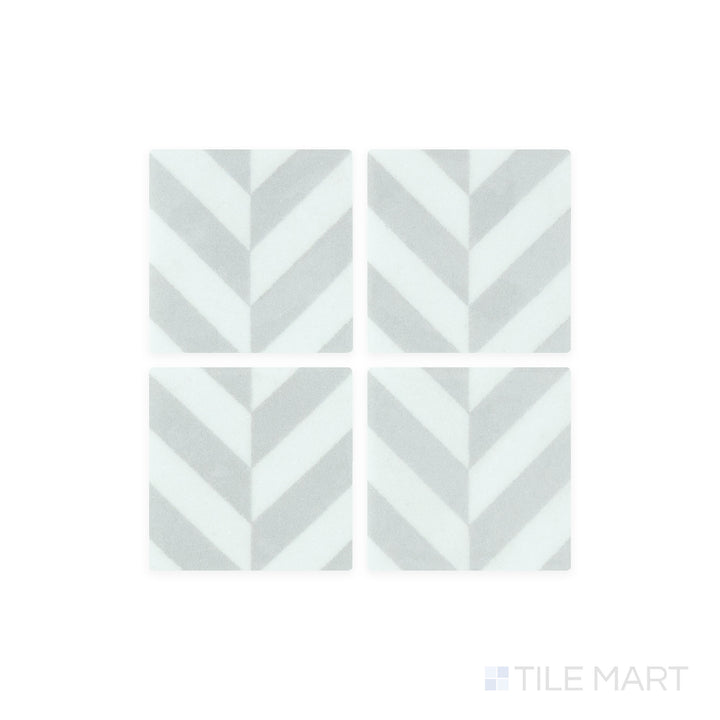 A close-up shot of Onix Glass - Icon Light Grey 2" Square Chevron Matte, Gloss Mosaic tile reveals its subtle grey hue with a delicate mix of matte and gloss textures for a modern aesthetic.