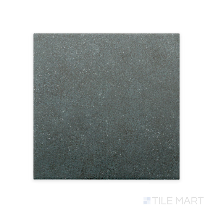 A detailed close-up of Stage Denim 4X4 matte porcelain tile captures its muted blue hue and velvety matte texture, adding a subtle pop of color to contemporary designs.