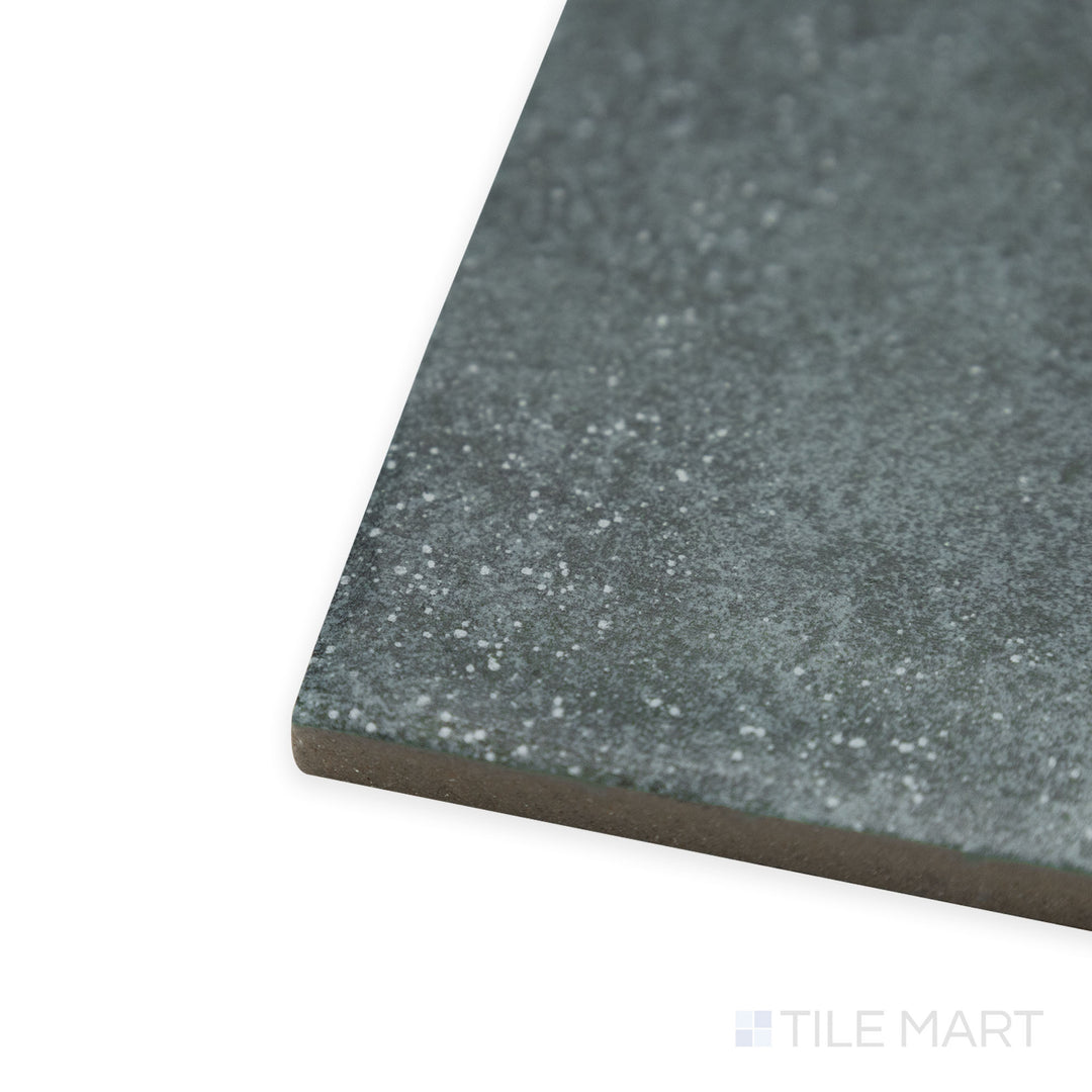 Side-corner view of Stage Denim 4x4 matte porcelain tile, featuring its rich blue hue, structured cut, and soft matte surface that absorbs light evenly.