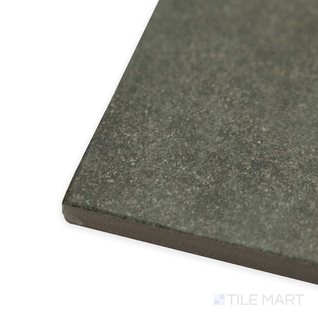 Corner-focused image of Stage Forest 4x4 matte porcelain tile, drawing attention to its deep green undertones, well-defined edges, and natural matte texture.