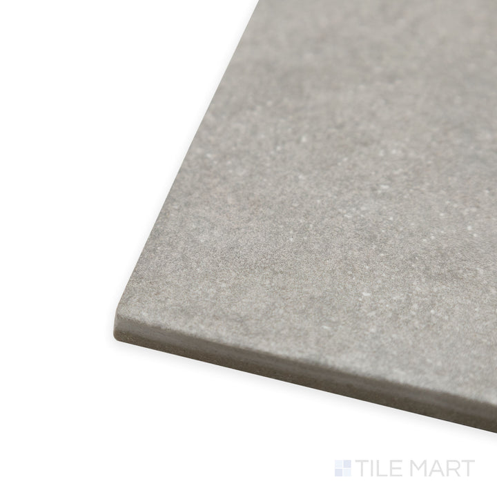 Angled view of Stage Grey 4x4 matte porcelain tile, highlighting its cool neutral tone, crisp edges, and the smooth, soft matte finish meeting at a seamless corner.