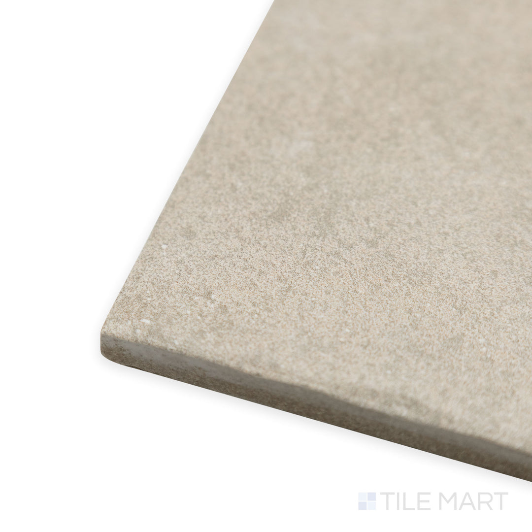 Corner shot of Stage Taupe 4x4 matte porcelain tile, emphasizing its muted taupe shade, structured format, and how the edges create a well-defined junction.