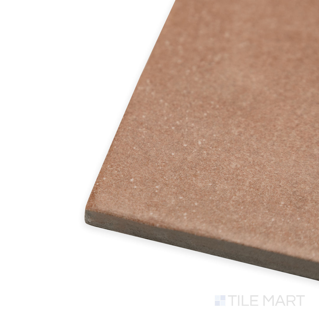 Side-angle perspective of Stage Terracotta 4x4 matte porcelain tile, featuring a warm reddish-brown hue, clean-cut edges, and a fine matte finish.