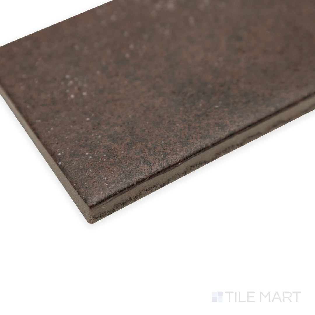 Angled corner view of Stage Brown 2.5x12 matte porcelain tile, showcasing its elongated form, soft matte surface, and the precise transition between its edges.