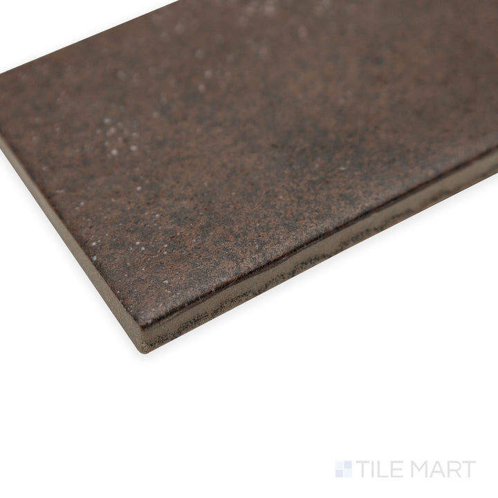 Angled corner view of Stage Brown 2.5x12 matte porcelain tile, showcasing its elongated form, soft matte surface, and the precise transition between its edges.