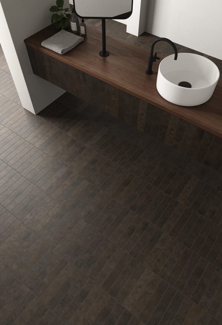 A rich, inviting atmosphere is achieved with Stage Brown 2.5X12 Matte Porcelain, adding a touch of warmth and depth to any space.