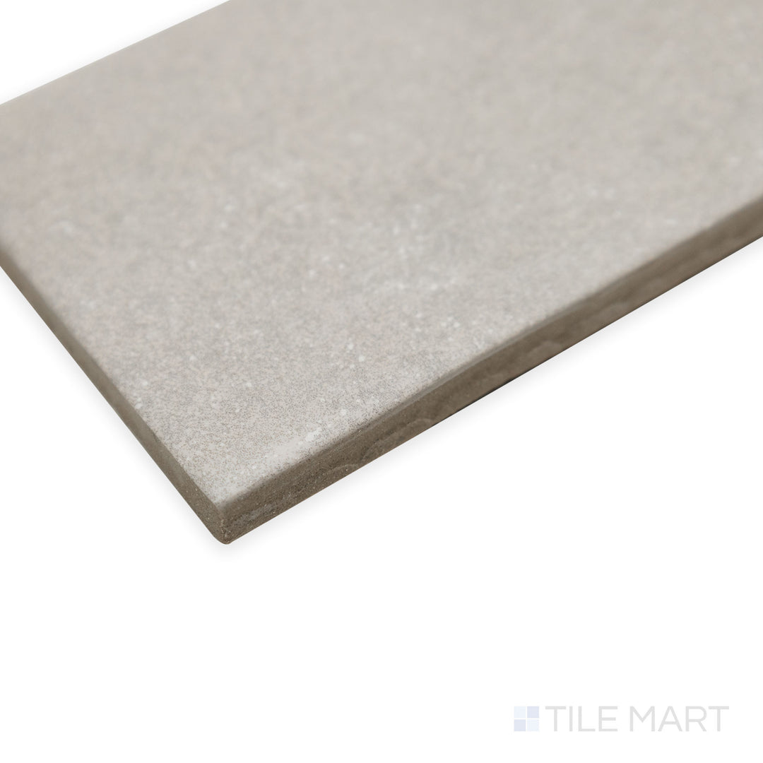 Angled view of Stage Grey 2.5x12 matte porcelain tile, showcasing its versatile neutral hue, refined matte surface, and sharp edge detailing.