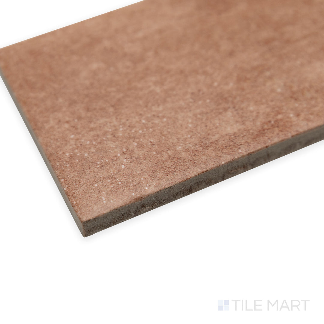 Side-corner view of Stage Terracotta 2.5x12 matte porcelain tile, drawing attention to its warm terracotta shade, crisp edges, and the way light subtly interacts with its matte finish.