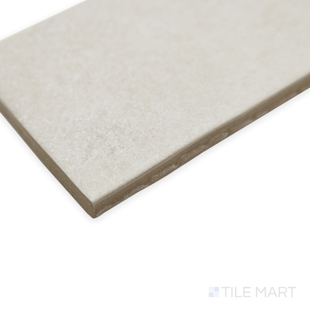 Angled close-up of Stage White 2.5x12 matte porcelain tile, emphasizing its pristine white tone, finely cut edges, and smooth, even matte surface.