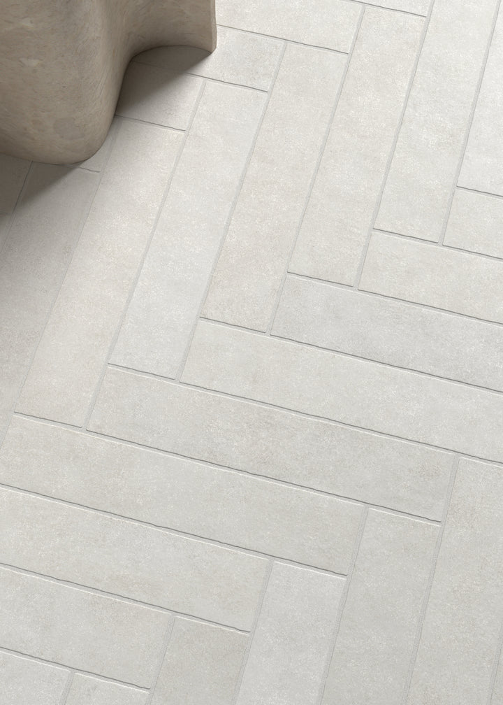 A timeless and clean design featuring Stage White 2.5X12 Matte Porcelain, creating a versatile and airy aesthetic.