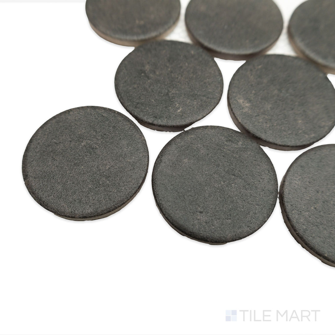 Angled view of Stage Charcoal 2" penny round matte porcelain mosaic, capturing the deep gray color, matte finish, and individual tile contours.