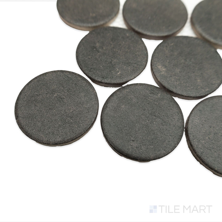Angled view of Stage Charcoal 2" penny round matte porcelain mosaic, capturing the deep gray color, matte finish, and individual tile contours.