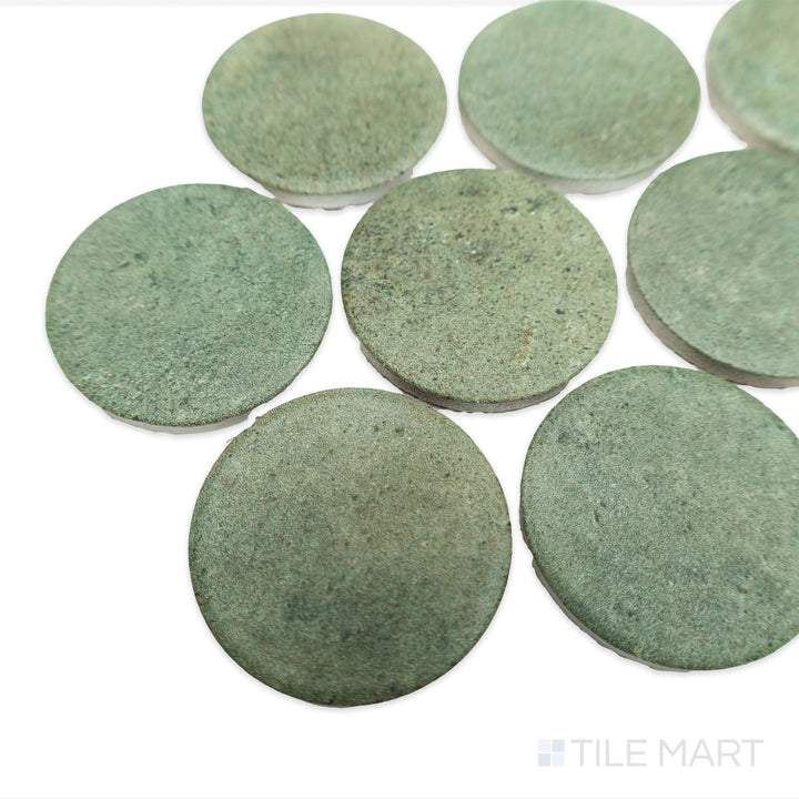 Corner shot of Stage Forest 2" penny round matte porcelain mosaic tile, highlighting its dark green hues, textured finish, and slight dimensional spacing.