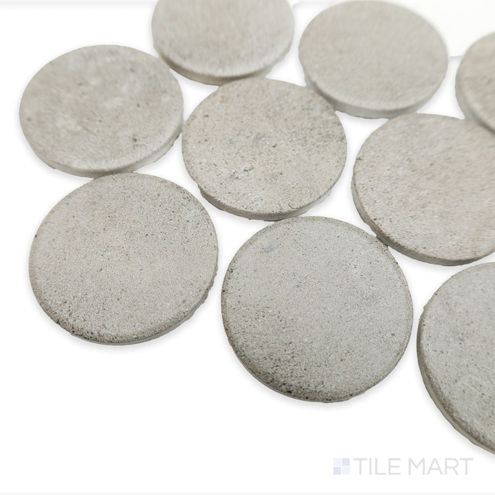 Stage Grey 2" penny round matte porcelain mosaic shown from an angled view, emphasizing soft gray coloration and uniform penny-round spacing.