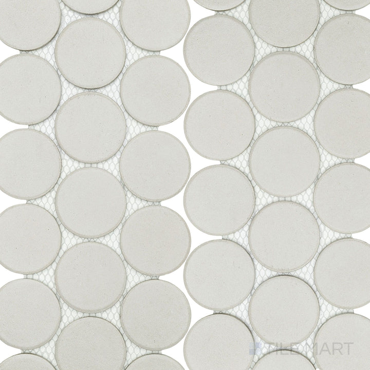 Stage White 2" penny round matte porcelain mosaic tiles laid out in a clean arrangement, highlighting their bright white color and soft matte surface.