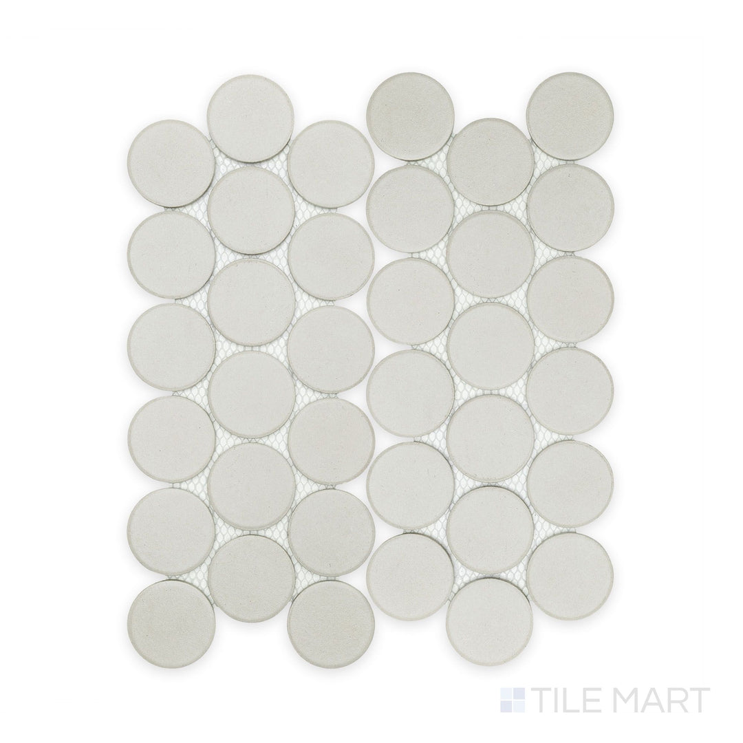 Captured in full from a top angle, the Stage White 2" penny round matte porcelain mosaic tile displays a clean white tone and neatly spaced circular layout.