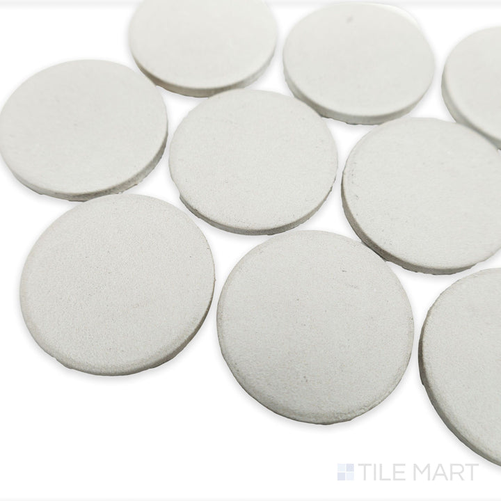 Angled view of Stage White 2" penny round matte porcelain mosaic tile highlighting its clean white glaze and uniform round tile layout.