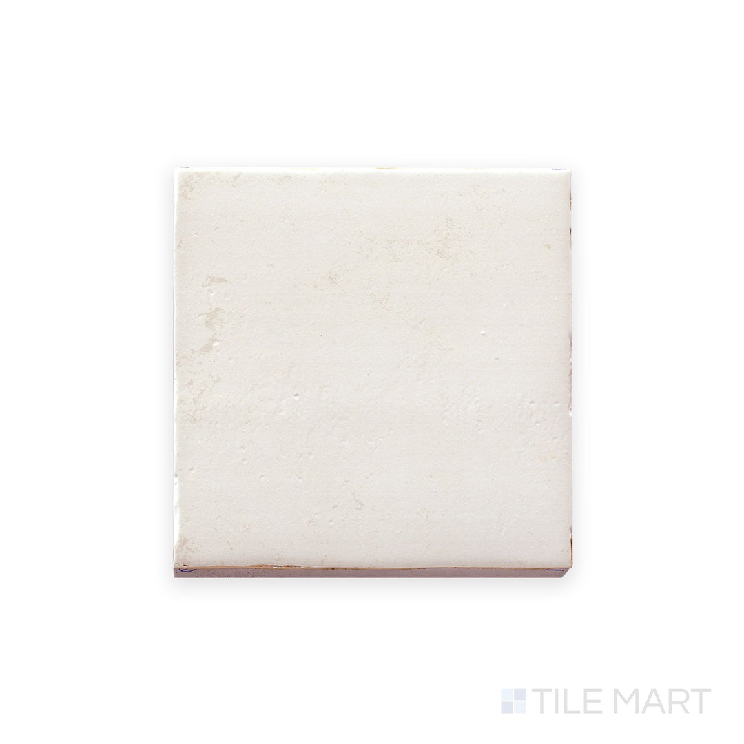 Top-down image of Fuego Blanco 9x9 matte porcelain tile, capturing its full square form with soft white tones and subtle surface texture.