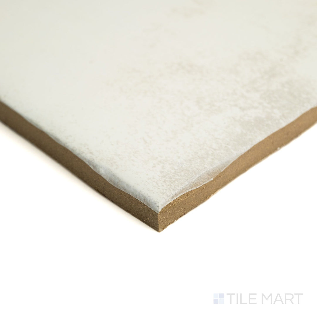 Corner angle of Fuego Blanco 9x9 matte porcelain tile, highlighting its soft white surface, rustic texture, and clean edge line.