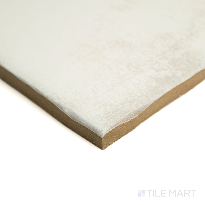 Corner angle of Fuego Blanco 9x9 matte porcelain tile, highlighting its soft white surface, rustic texture, and clean edge line.