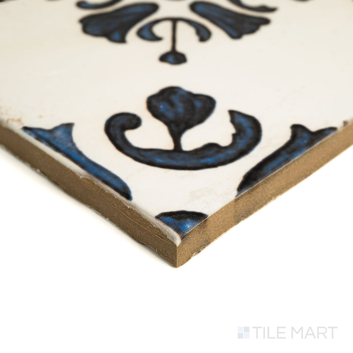 Angled view of Fuego Raices Deco 9x9 matte porcelain tile, showing its decorative pattern, subtle matte texture, and squared tile edge.