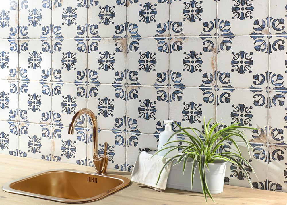 Fuego Raices Deco 9x9 matte porcelain tile in an installed layout, revealing its decorative pattern and handcrafted aesthetic with earthy undertones.