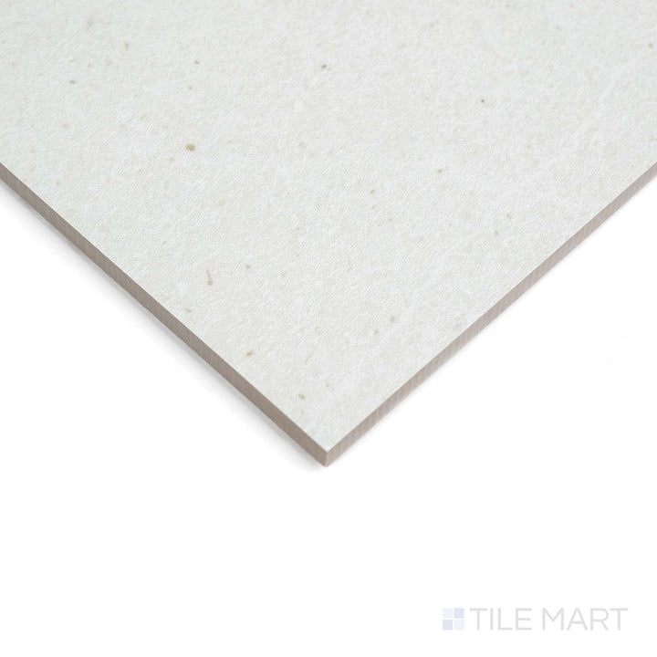 Corner view shows Lime Evolution Ice 48X48 matte ceramic tile, emphasizing its sleek surface and subtle texture.