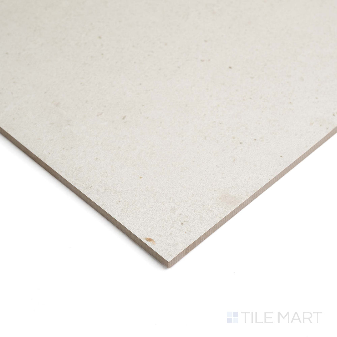Lime Evolution Moon 48X48 ceramic is shown from the side, highlighting its soft grey tone and matte finish.