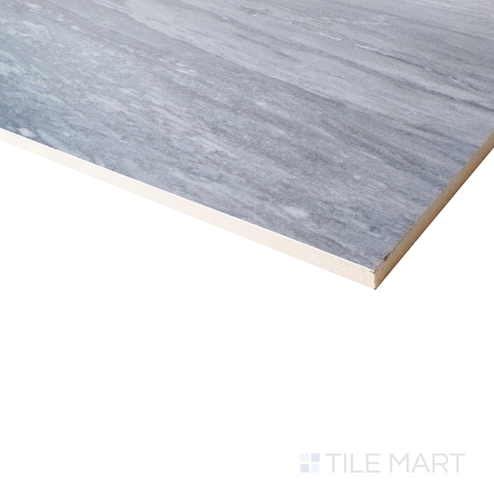 Corner perspective captures the dramatic veining and deep tones of Exotic Stone Nebula Blue Polished Porcelain.