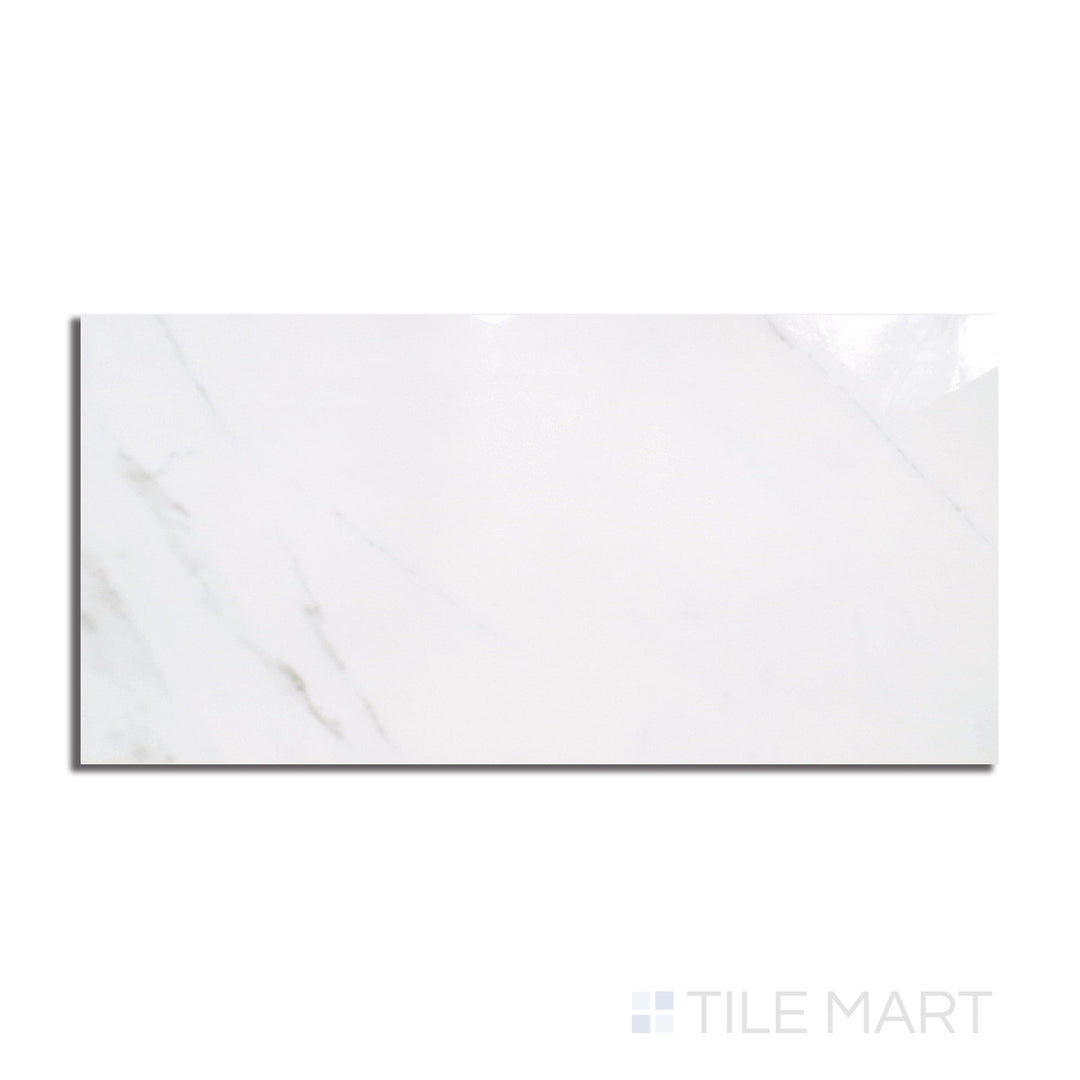 Top-down view of Marmolab Calacatta 24x48 glossy porcelain tile, showing bold veining across a white marble-look surface with a polished sheen.
